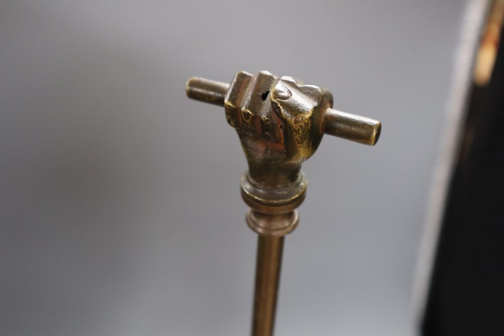 A coloured and carved wood door porter, the brass handle with clenched fist finial, height 71cm
